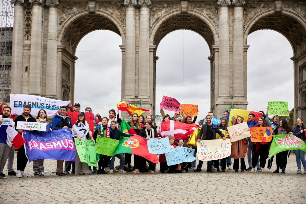 Fahnenparade im Parc du Cinquantenaire des Erasmus Student Network - viele Menschen stehen zusammen und halten Fahnen